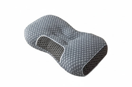 Gray pillow with honeycomb pattern on a bed